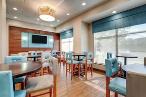 Relax in a spacious room with a large seating area, flat-screen TV, and large windows offering views of the outside.