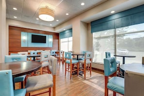 Relax in a spacious room with a large seating area, flat-screen TV, and large windows offering views of the outside.