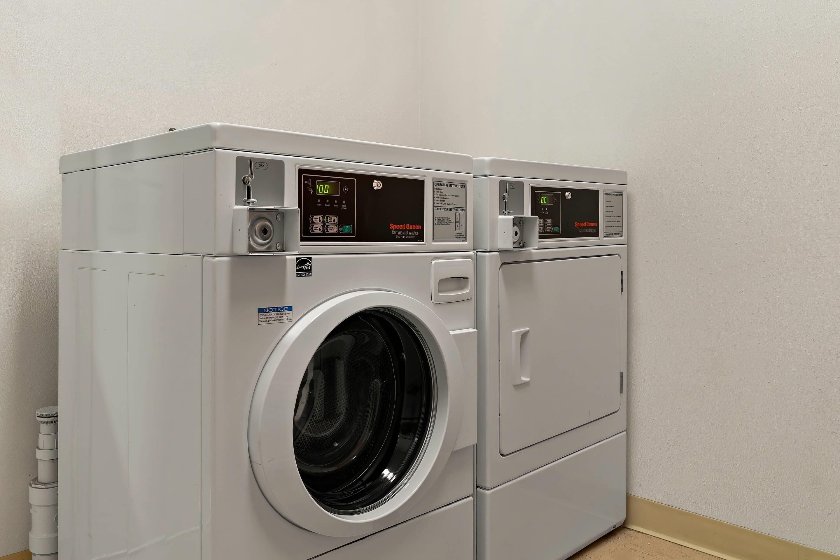 A front-loading, stacked washer and dryer unit with digital displays and control panels.