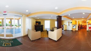 A hotel lobby with a reception desk, seating area, and a fireplace. - Quality Inn Greenwood Hwy 25 (Greenwood)