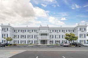 Stunning hotel with a central entrance and symmetrical facade, featuring windows on either side.