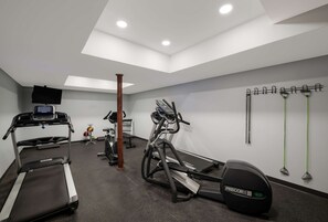 A gym with treadmills, an elliptical, and a stationary bike. - SureStay Plus by Best Western Woodbury Inn (Woodbury)