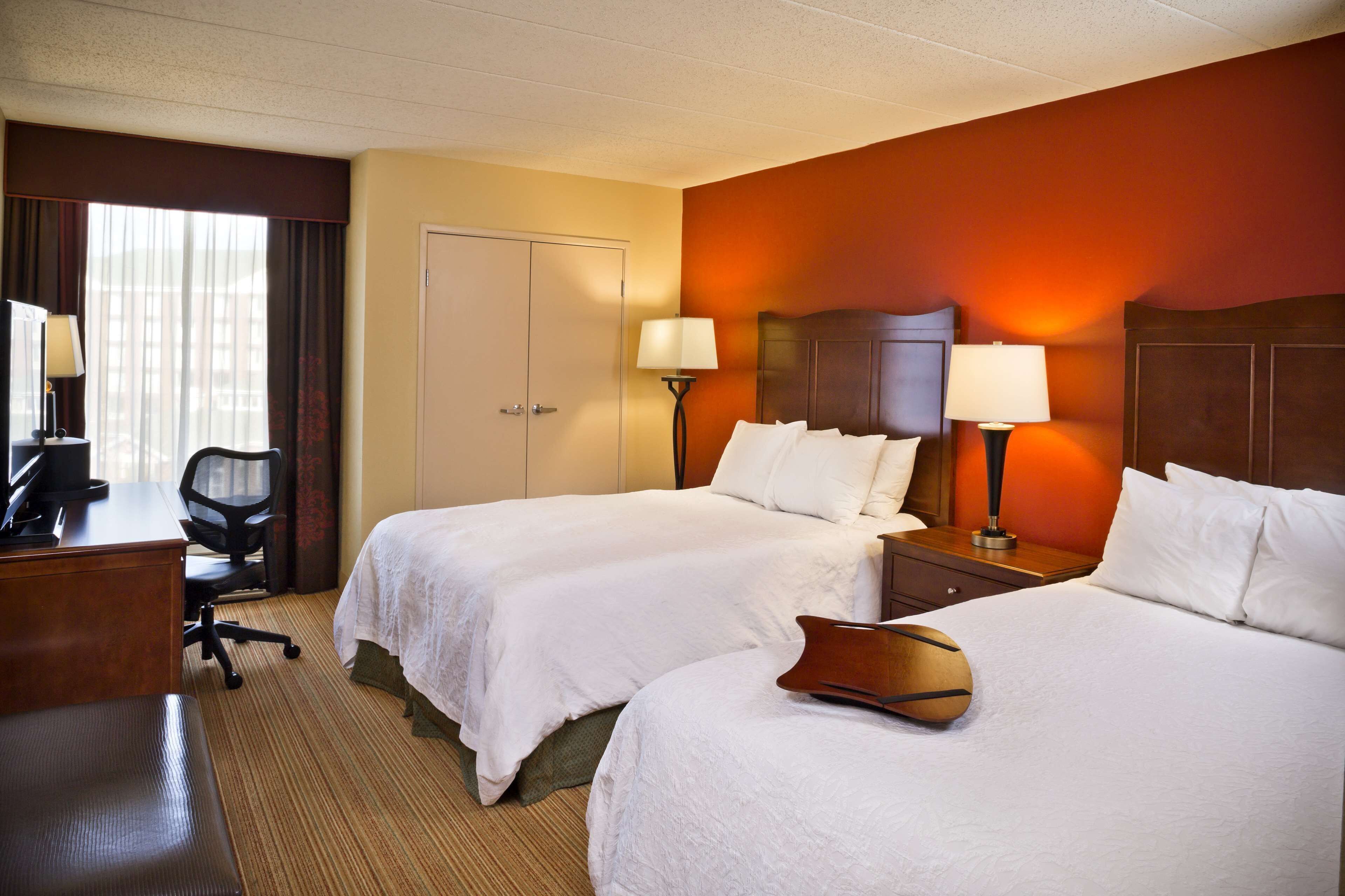 Hypo-allergenic bedding, desk, laptop workspace, blackout drapes