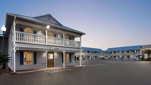 A motel with a two-story structure, a balcony, and a 'Lobby' sign.