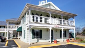 A two-story building with a balcony, labeled "LOBBY," featuring a porch and a green awning. - Keywest Inn - Tuscumbia/Muscle Shoals (Tuscumbia)