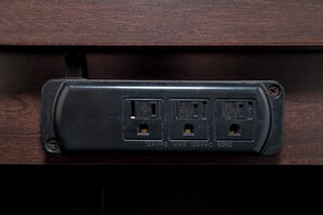 A power strip with three outlets, a USB port, and a switch. - Red Roof Inn PLUS+ & Suites Opelika (Opelika)