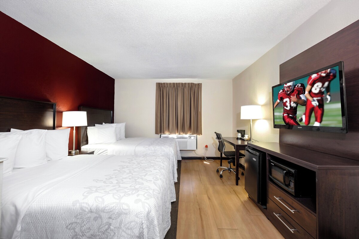 Premium bedding, desk, laptop workspace, blackout drapes