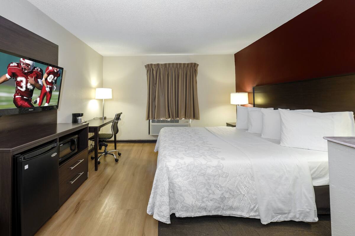 Premium bedding, desk, laptop workspace, blackout curtains