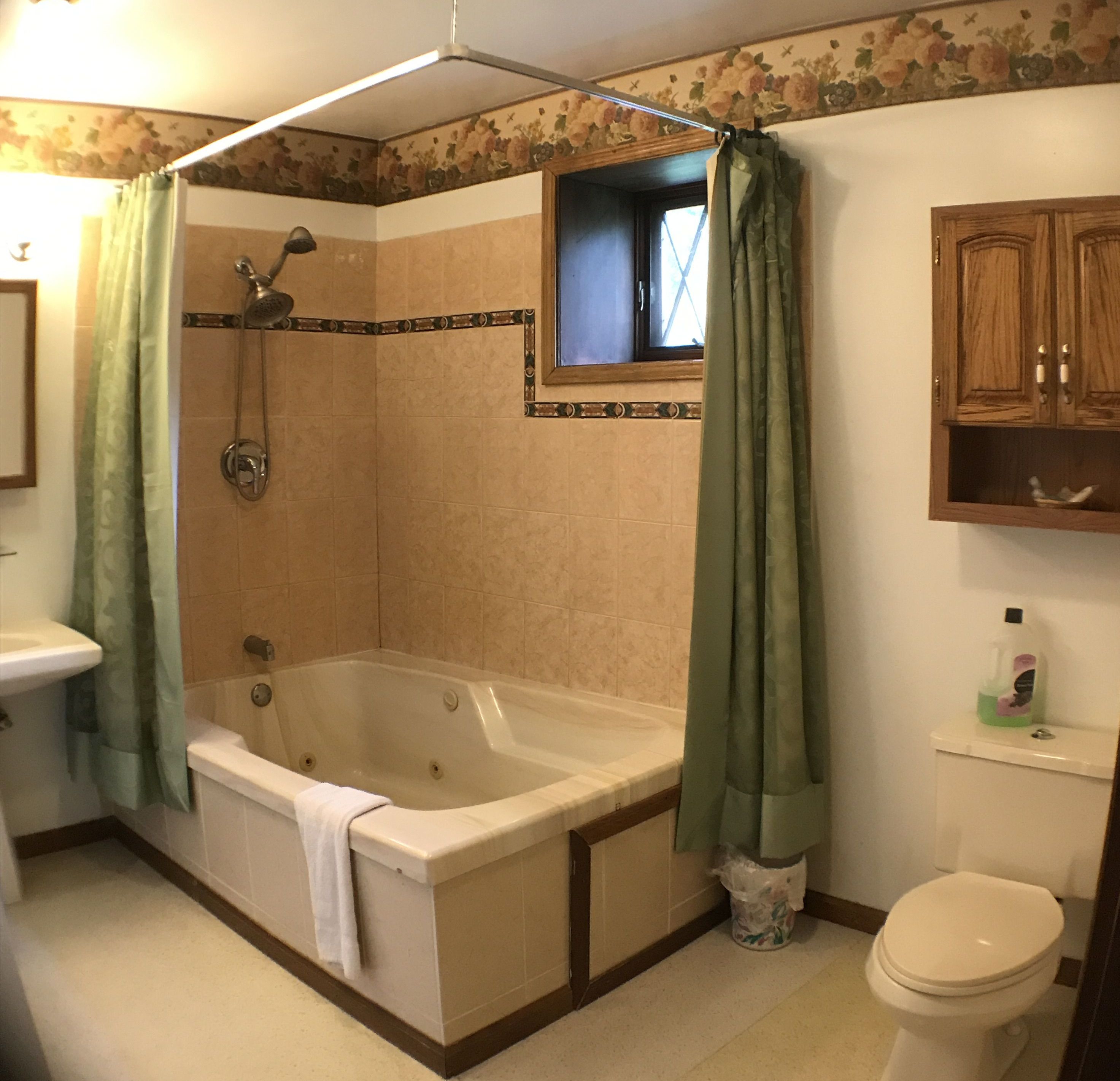 A bathroom with a bathtub, shower, toilet, and a sink.