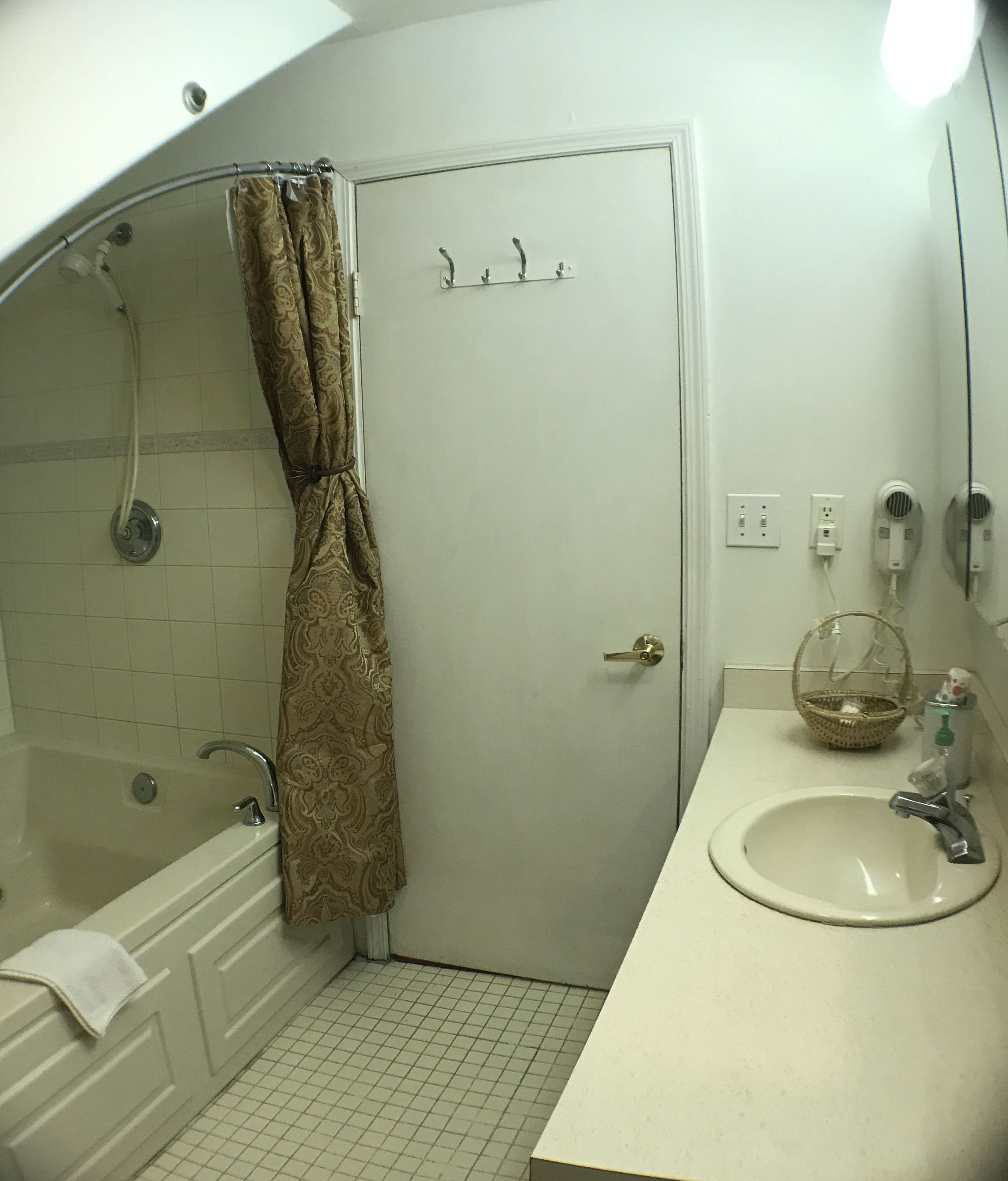 A bathroom with a bathtub, a sink, and a shower.
