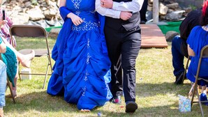 A wedding ceremony outdoors with guests seated on chairs. - 7 Gables Inn & Suites (Fairbanks)