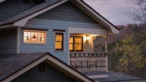 A two-story house with a porch and a small balcony. - Arsenic and Old Lace B&B (Eureka Springs)