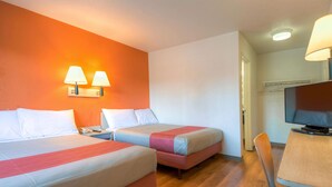 A hotel room with two beds, a desk with a chair, a television, and two wall-mounted lamps. - Motel 6 San Ysidro, CA - San Diego - Border (San Ysidro)