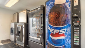 A vending machine with a Pepsi logo, a refrigerator, and a microwave. - Motel 6 San Ysidro, CA - San Diego - Border (San Ysidro)