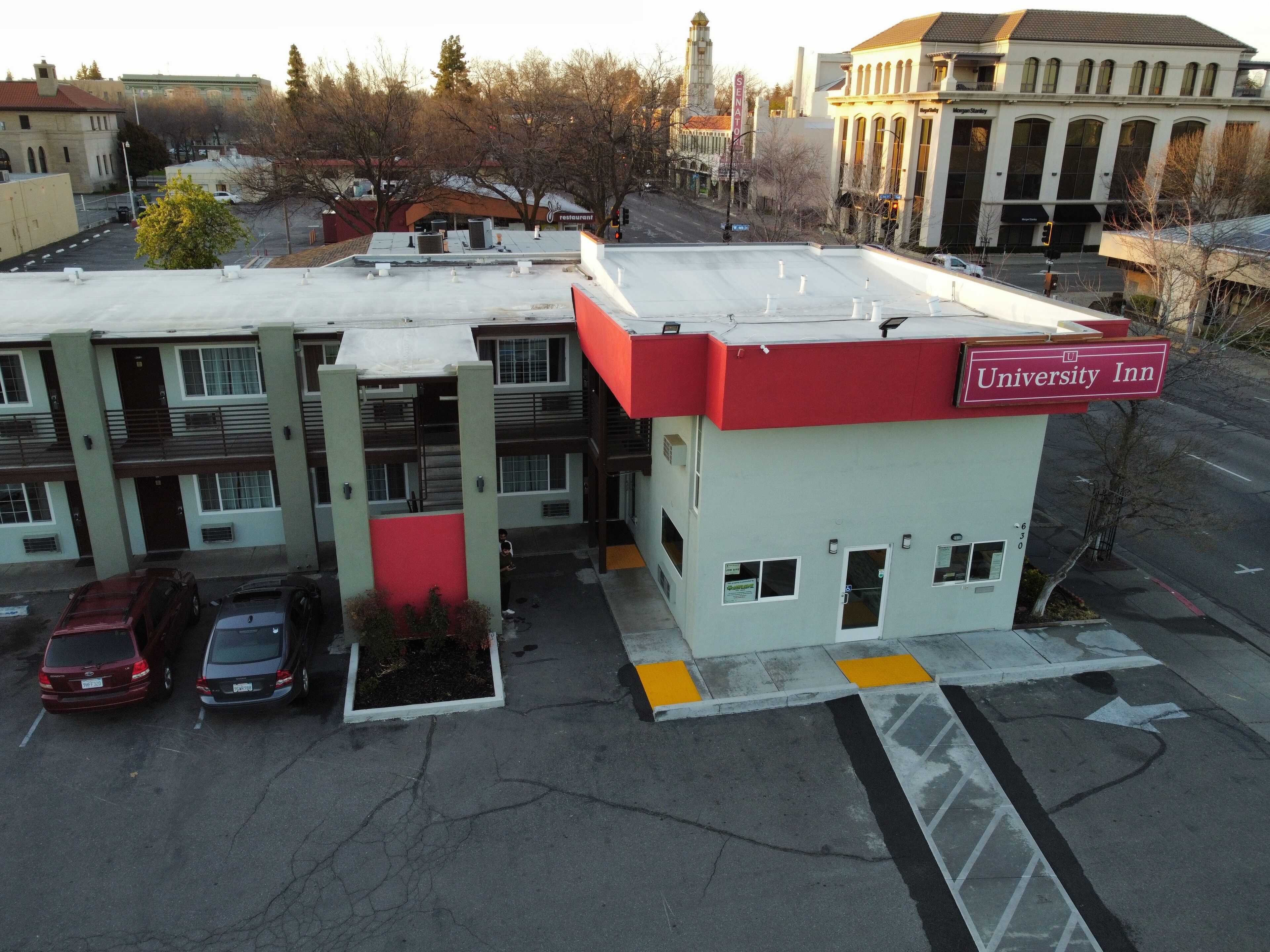 A building with a red and white sign labeled "University Inn."