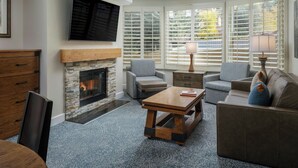 A living room with a fireplace, comfortable seating, and large windows. - Marriott's StreamSide Evergreen at Vail (Vail)