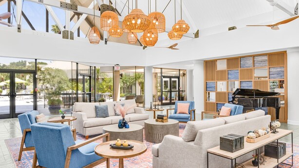 A spacious lobby with modern furniture, large windows, and a grand piano. - Marriott's Sabal Palms (Orlando)