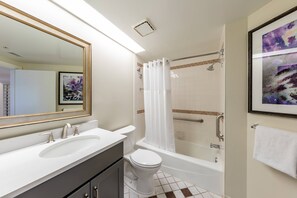 A bathroom with a double sink vanity, a toilet, a bathtub, and a shower with a glass door. - Marriott's Imperial Palm Villas (Orlando)