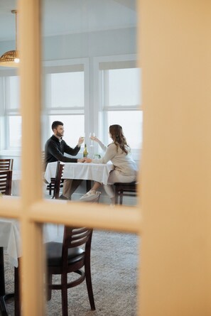 A dining area with a table, chairs, and a window.