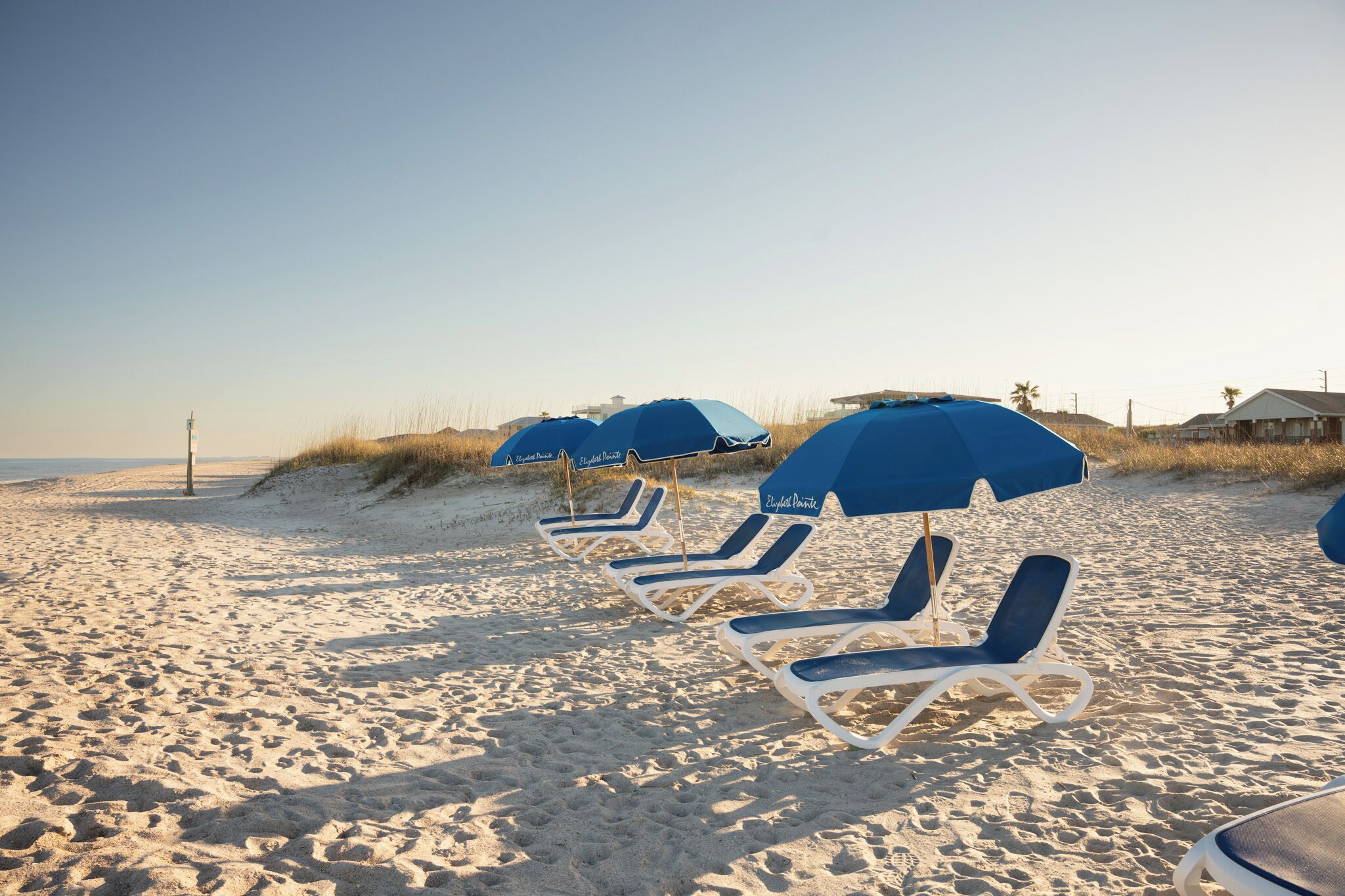 On the beach, white sand, sun loungers, beach umbrellas