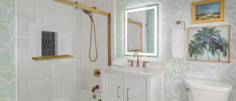 Un baño con ducha, lavamanos con espejo, inodoro y detalles decorativos en la pared.