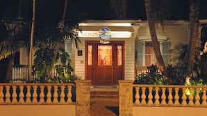 A hotel entrance with a sign reading "Heron House Office."