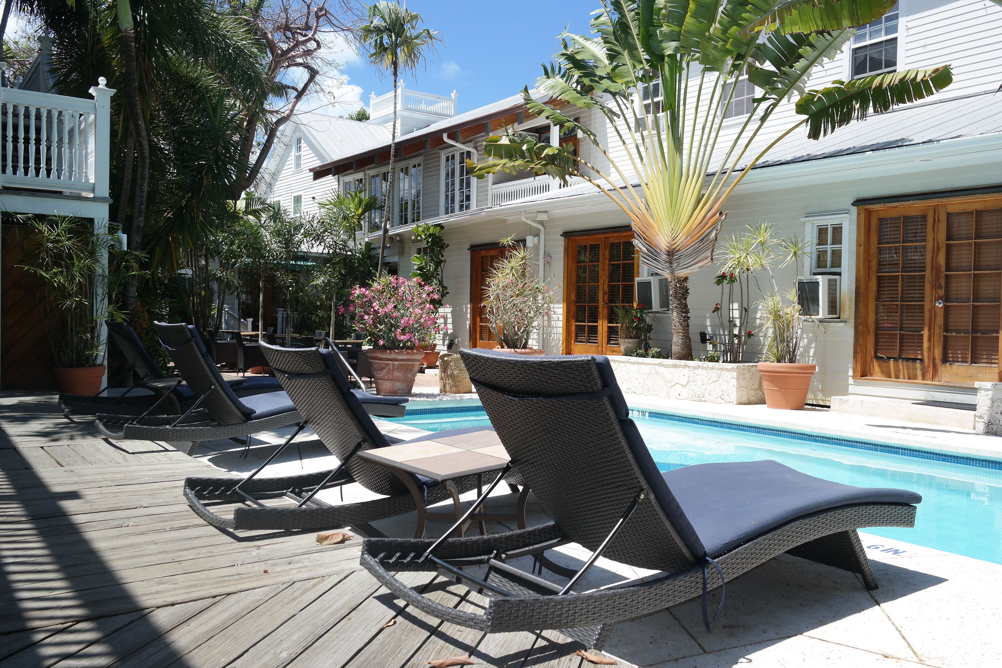A poolside area with lounge chairs and a pool.
