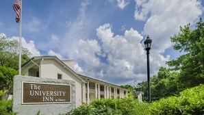 A building with a sign reading "The University Inn at Emory" and an American flag. - The University Inn at Emory (Atlanta)