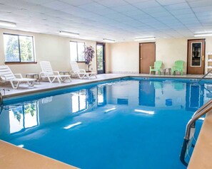An indoor swimming pool with white lounge chairs and a potted plant. - Quality Inn & Suites Lebanon I-65 (Lebanon)