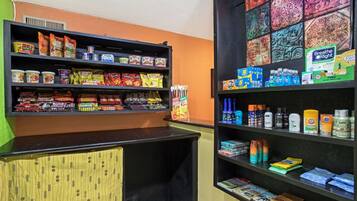 A store with shelves stocked with snacks, beverages, and toiletries.
