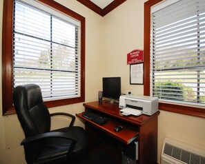 A business center with a desk, computer, printer, and chair. - Econo Lodge Russellville (Russellville)
