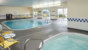 An indoor swimming pool with yellow chairs and a separate hot tub area. - Fairfield Inn By Marriott Port Huron (Port Huron)