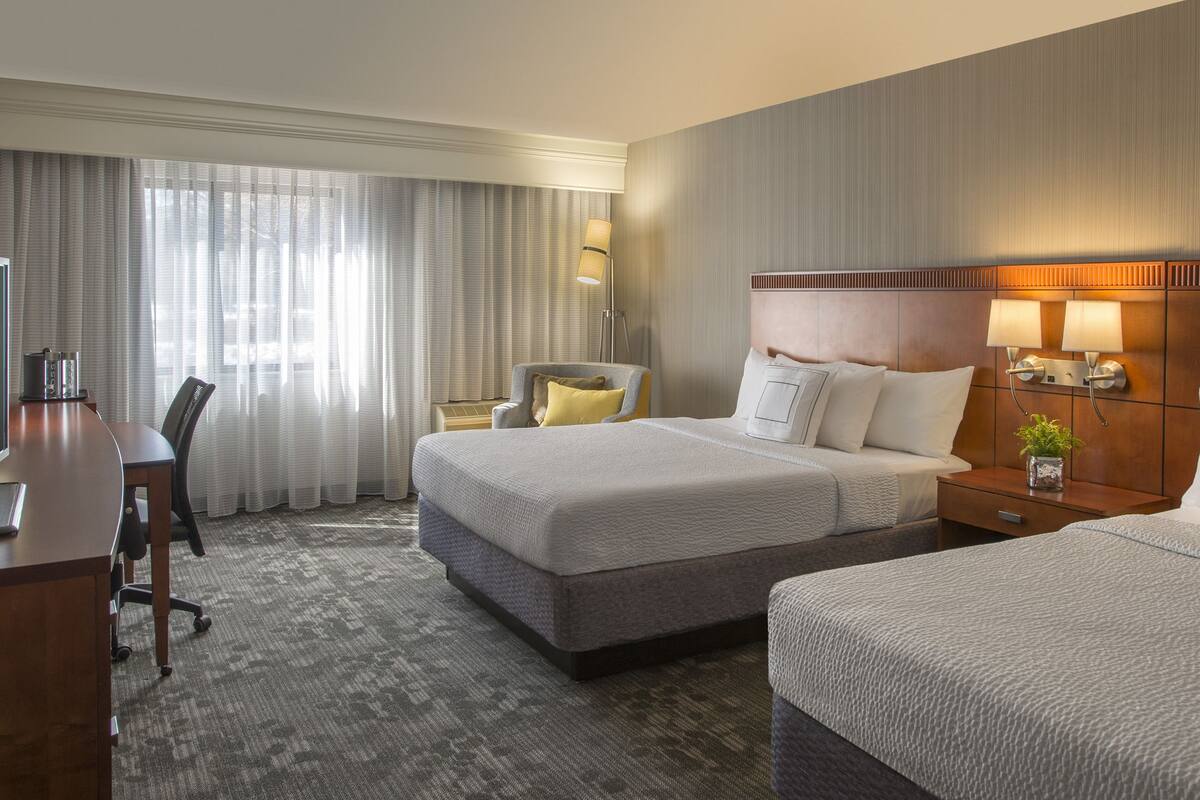 Premium bedding, desk, laptop workspace, blackout drapes