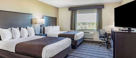 A hotel room with two beds, a desk, a television, and a large window with a view.