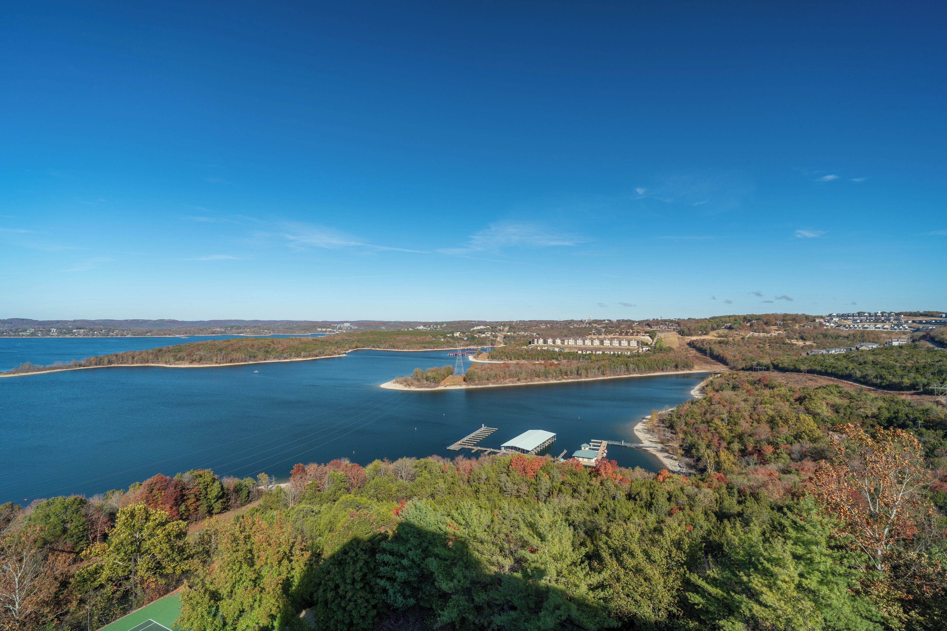 A large body of water with a bridge and buildings in the background.