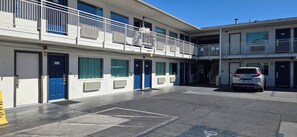 A multi-story motel with individual rooms, a parking area, and a stairway leading to the upper level. - Studio 6 Suites Las Vegas, NV – Tropicana (Las Vegas)