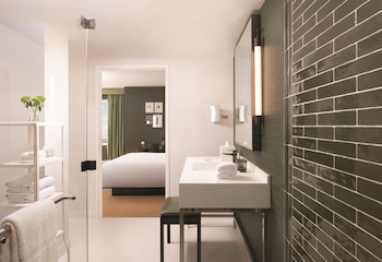 Skylark Suite | Bathroom | Shower, eco-friendly toiletries, hair dryer, towels at Park MGM Las Vegas