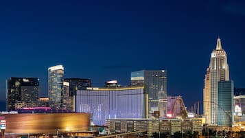 A city skyline with prominent buildings including a large hotel with a distinctive curved facade and a tall, ornate tower.