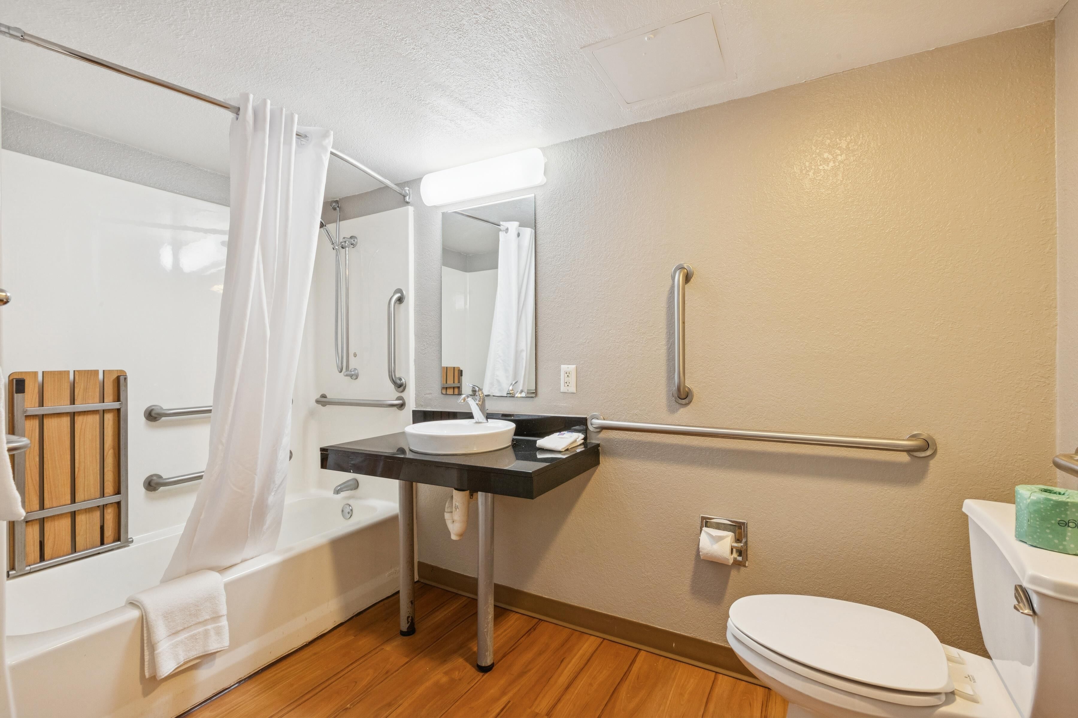 A bathroom with a bathtub, a sink, a toilet, and a shower.