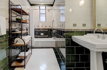 Premium Single Room, 1 King Bed, Accessible | Bathroom | Rainfall showerhead, free toiletries, hair dryer, bathrobes at Casablanca Hotel by Library Hotel Collection