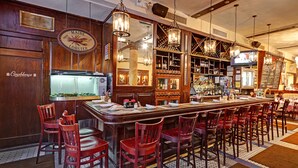 Un bar con decoración de madera, un letrero con forma de langosta y un espejo grande.