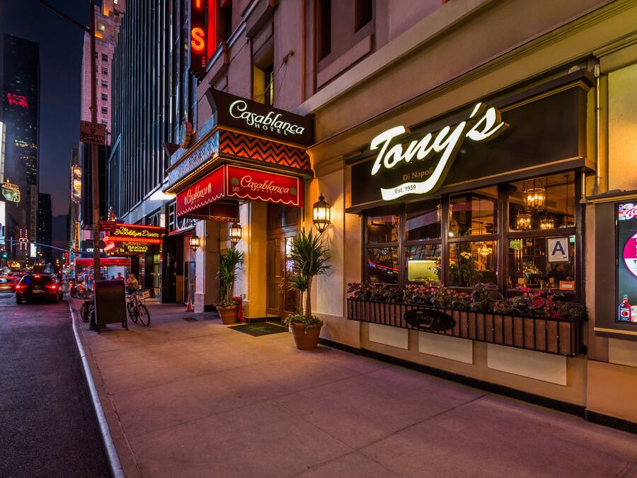A nighttime street view with Tony's restaurant and adjacent buildings.