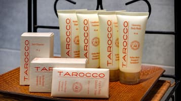 A variety of skincare products from the brand Tarocco, including a cleansing body wash, face and body cleanser soap, and a skin cleanser.