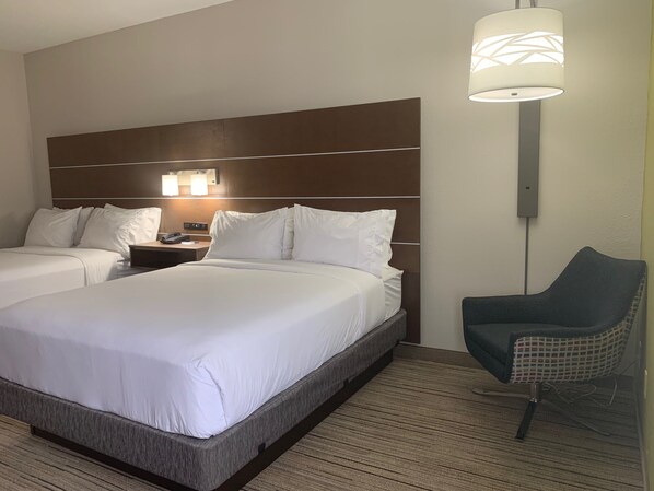 A hotel room with two beds, a nightstand, a lamp, and a chair. - Holiday Inn Express Hillsborough by IHG (Hillsborough)