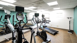 A fitness center with treadmills, elliptical machines, and a stationary bike.