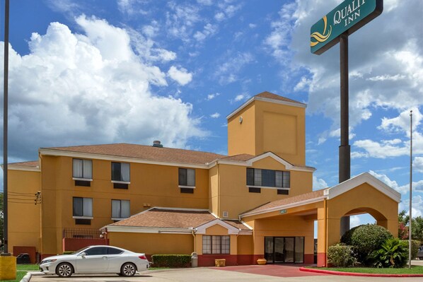 Quality Inn features a covered entrance with an arched roof and ample parking.