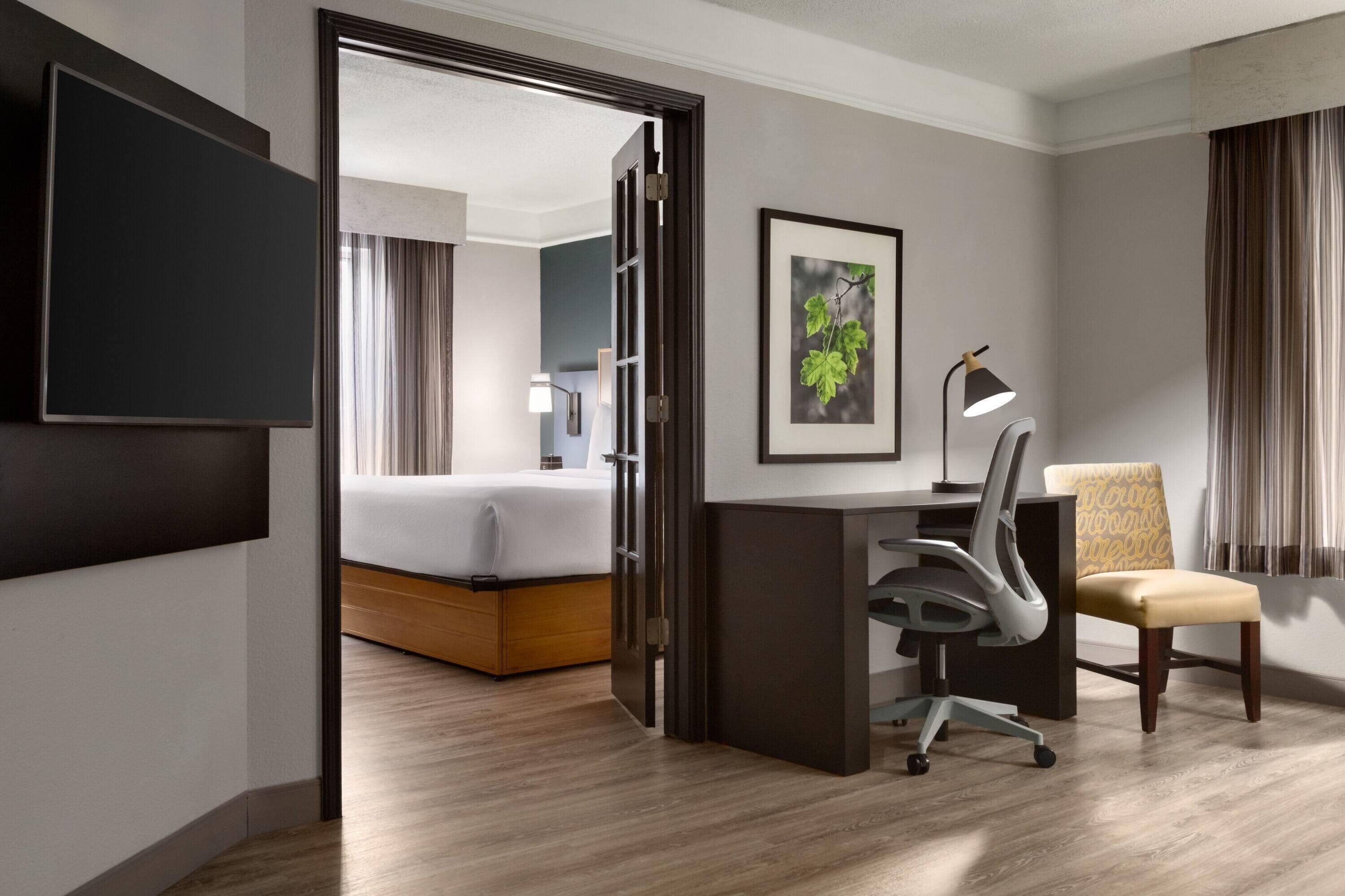 Premium bedding, desk, laptop workspace, iron/ironing board