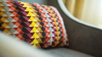 A close-up of a patterned pillow on a couch.