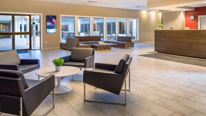 A modern lobby with a reception desk, seating area, and large windows. - Red Lion Hotel Kennewick Columbia Center (Kennewick)