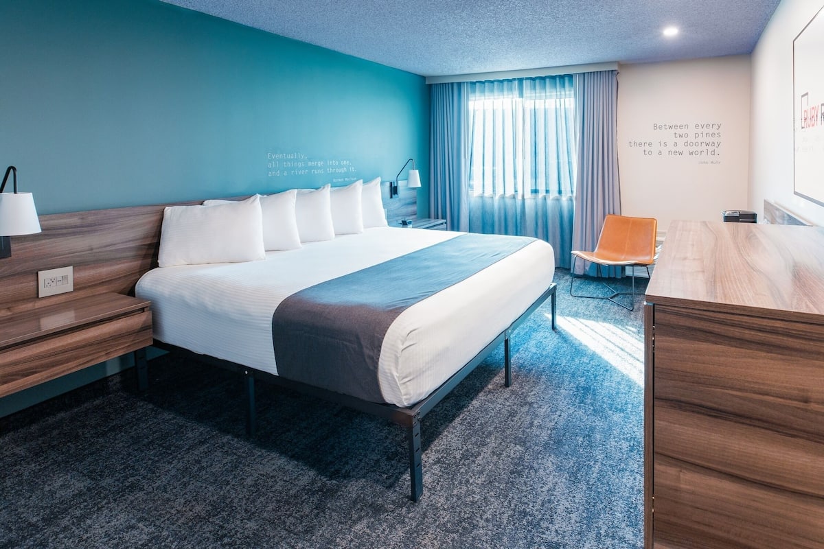 Premium bedding, desk, laptop workspace, blackout drapes